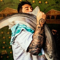 Africola's Duncan Welgemoed with a tea towel and giant fish slung over his shoulder.