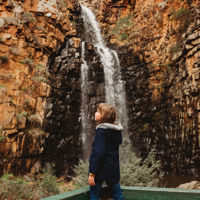 Child standing watching the waterfall cascade at Morialta Conservation Park