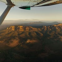 Plane flying over the Flinders Ranges with a bird's-eye view of Wilpena Pound